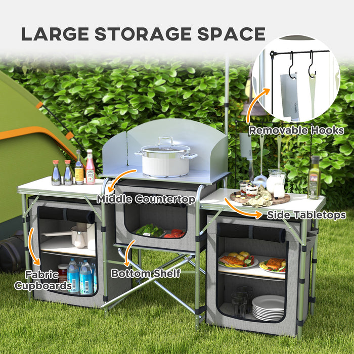 Portable Aluminum Camping Kitchen Station - Foldable Table with 3 Fabric Storage Cupboards, Windshield, Light Holder - Ideal for BBQ, RV Trips, and Outdoor Picnics