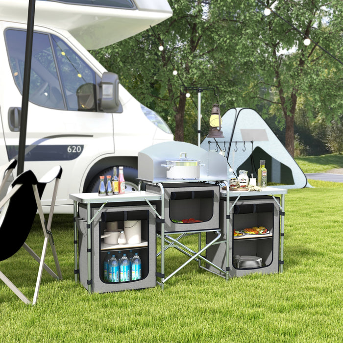 Portable Aluminum Camping Kitchen Station - Foldable Table with 3 Fabric Storage Cupboards, Windshield, Light Holder - Ideal for BBQ, RV Trips, and Outdoor Picnics